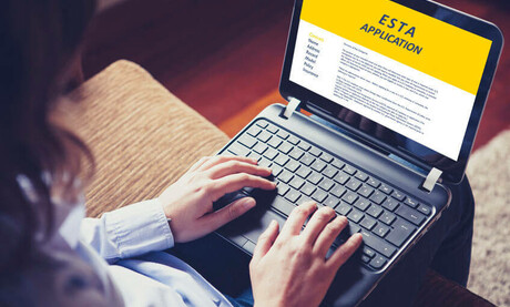 woman doing electronic ESTA application in a laptop